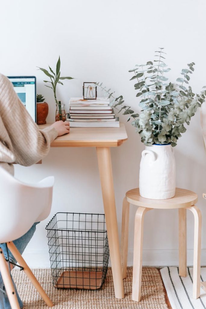 pexels photo 7034717 Cozy workspace with a laptop, books, and plants, promoting a relaxed, creative atmosphere.